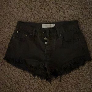 Brown/black jean shorts with a frayed bottom from the boutique nectar!
